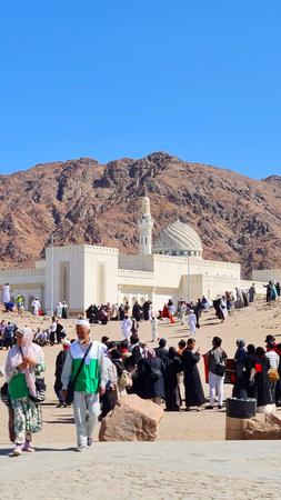 Mecca, Saudi Arabia on 24 February 2024. Many people are walking near the building with dome and...