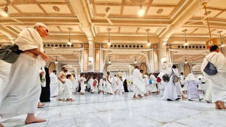 Mecca, Saudi Arabia on February 25, 2024. Several individuals are walking inside a building featuring arched passages and an intricately designed ceiling, suitable for travel and cultural concepts.のeditorial素材