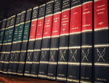 Jakarta, Indonesia on 1 Jun 2025. A collection of aged books stand neatly aligned on a wooden shelf, inviting readers to explore their literary treasures and expand their knowledge Perfect for book lovers and learning resources.のeditorial素材