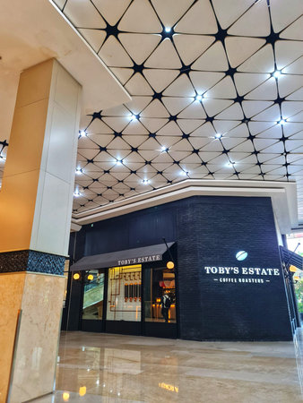 Jakarta, Indonesia on 8 Jun 2025. A stylish cafe facade is captured beneath a modern ceiling with a...