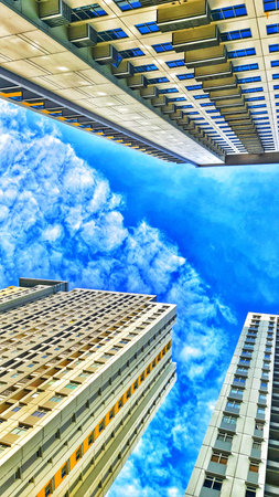 Bekasi, Indonesia on 1 Feb 2024. three modern high rise buildings viewed from below against a vibrant blue sky with fluffy white clouds The buildings are tall with numerous windows and balconies creating a striking contrast with the natural elements The pのeditorial素材