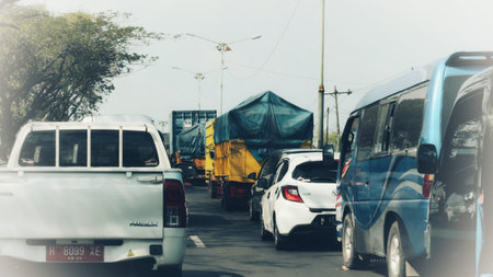 Jepara, Indonesia on 12 Oct 24. a traffic jam on a city road. Various vehicles including trucks,...