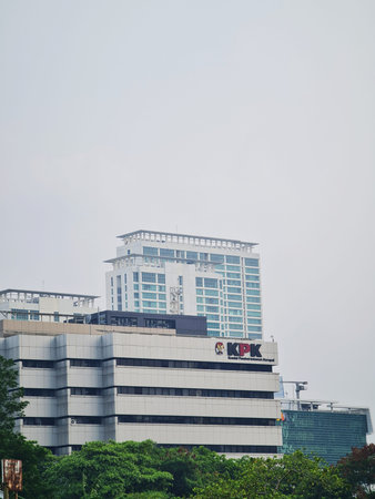 Jakarta, Indonesia on 28 Sep 2024. A photograph of the KPK building in a city setting. The image features a modern, multi-story building with a simple design against a pale sky. The KPK logo is clearly visible on the building. Other buildings are partiallのeditorial素材