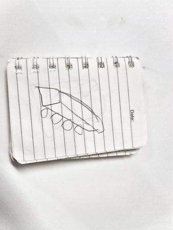 Bekasi, Indonesia on 31 Aug 2024. A child's simple pencil drawing of a boat is shown on a piece of lined notebook paper. The boat is depicted with a flat bottom and rounded top, resting on what appears to be wheels. The sketch is uncomplicated and shows bのeditorial素材