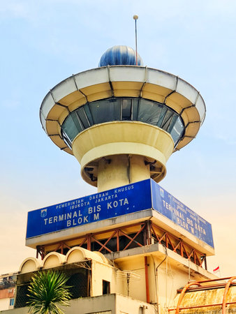 Jakarta, Indonesia on 15 Sep 24. the control tower of Terminal Bis Kota Blok M in Jakarta. The tower features a distinctive dome-shaped structure and a blue sign indicating its function. The sky is clear and the overall mood is calm and functional.のeditorial素材