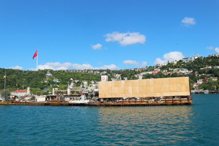 Istanbul, Turkey on 12 July 2022. Bosphorus. Structure being moved on the water with a national flag...