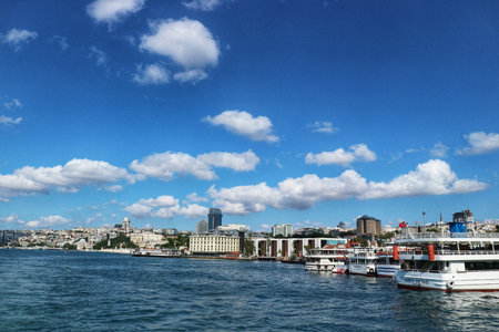 Istanbul, Turkey on 12 July 2022. Bosphorus. Waterside cityscape with boats on the water under a blue sky dotted with fluffy clouds, ideal for travel and vacation themes.のeditorial素材