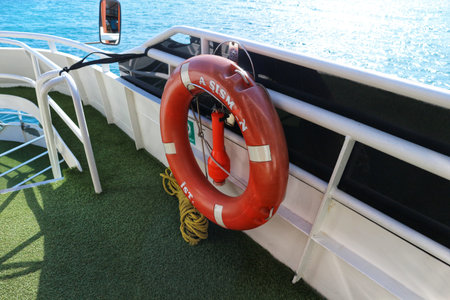 Istanbul, Turkey on 12 July 2022. An orange life preserver hangs on the railing of a ship overlooking the ocean creating a sense of safety and security Use for travel or safety concepts.のeditorial素材