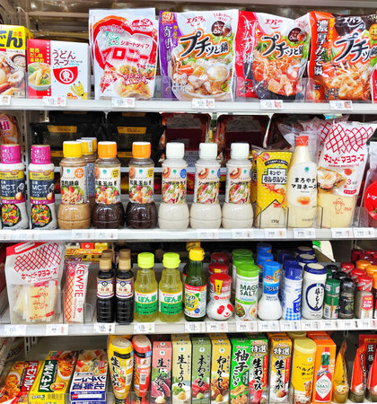 Retail shelves are stocked with diverse food products in vibrant packaging, creating an organized and appealing display for shopping and consumer marketing.のeditorial素材