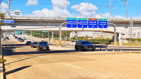 Busan, South Korea on 9 Nov 2024. Several cars move along a city expressway under a bridge on a...