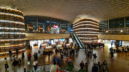 Seoul, South Korea on 7 Nov 2024. Starfield COEX Mall. Many people are walking within a bright, high-ceilinged library interior with massive decorative bookshelves and an escalator, creating a busy, intellectual atmosphere, suitable for educational or arcのeditorial素材