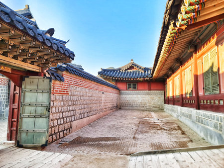 Seoul, South Korea on 10 Nov 2024. Korean architecture features colorful ornate details on buildings with a courtyard, set against a bright blue sky, ideal for travel or cultural content.のeditorial素材