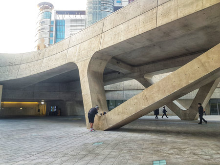 Seoul, South Korea on 7 Nov 2024. Dongdaemun Plaza.People are walking and interacting with modern concrete architecture and gray tiled ground, creating a sense of urban exploration and lifestyle, ideal for architectural designs.のeditorial素材