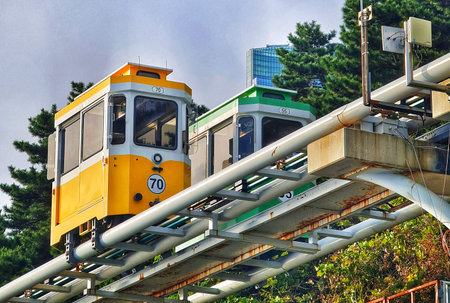 Busan, South Korea on 9 Nov 2024. Yellow and green elevated rail cars sit on a metal track among...