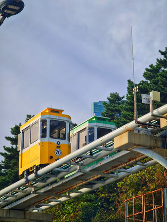 Busan, South Korea on 9 Nov 2024. Two rail cars running on elevated tracks create a unique public...
