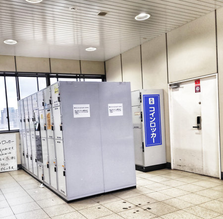 Osaka, Indonesia on 18 Oct 2025. Indoor corridor with metal coin lockers and a blue sign, suggesting...