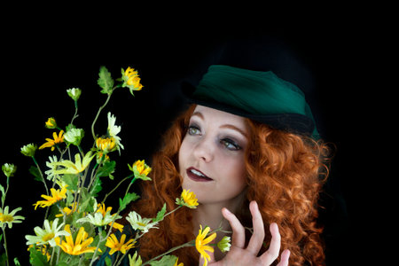Beautiful young woman wearing top hat with green tulle wrapped abound the top