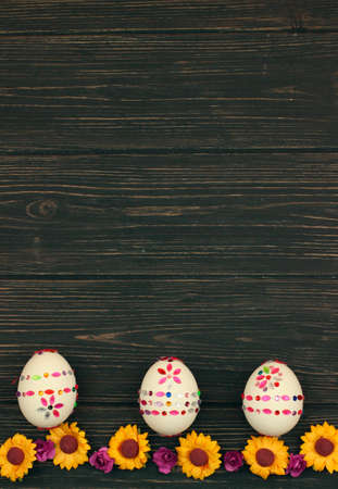 Three easter eggs with spring flowersの写真素材