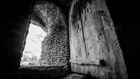 Old wooden door in the stone aisleの写真素材