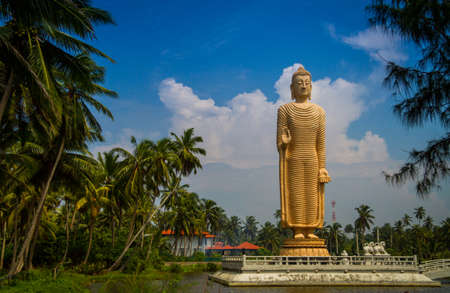 Buddha statue on a background of cloudsの写真素材
