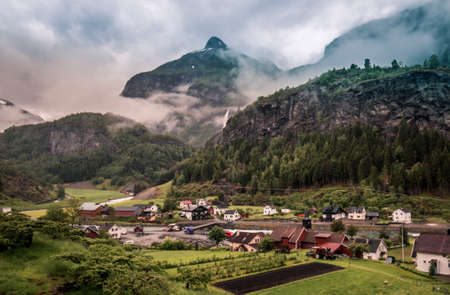 Varied landscape of the train tour with the waterfall in background. The Flamsbana way from Flam to Myrdal, Norway.の写真素材