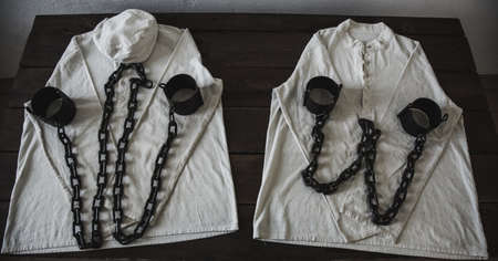 Prison Shackles on a White Shirtの写真素材