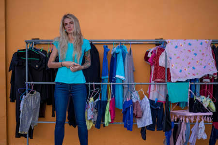 The modern housewife is on the roof in the background hanging linen. Doomed species. The modern woman.の写真素材