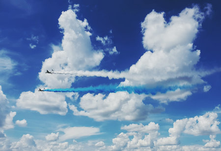 Two IL-76 planes produce blue and white smoke in the clouds in the sky over Russia. Russian...