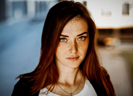 Beautiful red-haired girl looking at the camera. Portrait of a close-up. Natural beauty. Without makeupの写真素材