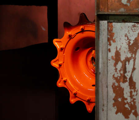 Orange gear on painting. Half the details. Rusty itemsの写真素材