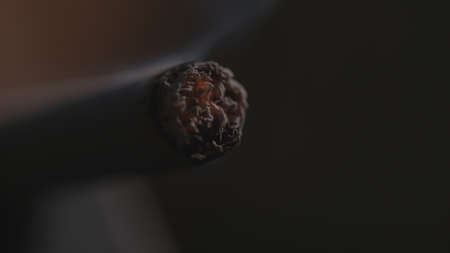 Burning end of a cigarette macro backgroundの写真素材