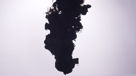 Ominous black ink, smoke over white backgroundの写真素材