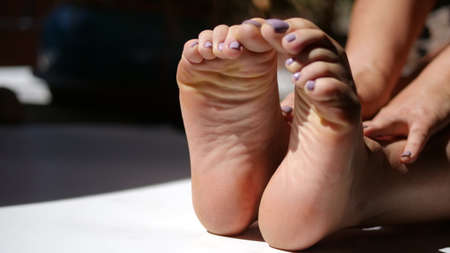 Feet of a young woman with pedicure close-up.の写真素材