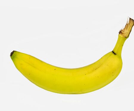 Single banana lying with white background.の写真素材