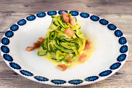 Zucchini alla carbonara with eggs and bacon A twist on the traditional Italian carbonara using zucchini noodles instead of spaghetti and omitting the cream for a gluten free, low carb version of the dの写真素材