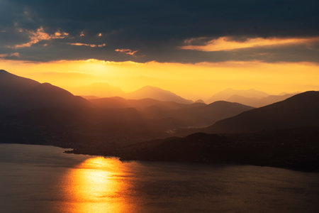 View of Lake Maggiore towards Luino at dawn taken from the viewpoint of Premenoの写真素材