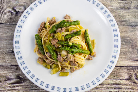 Spaghetti with asparagus, sausage and brie cheeseの写真素材