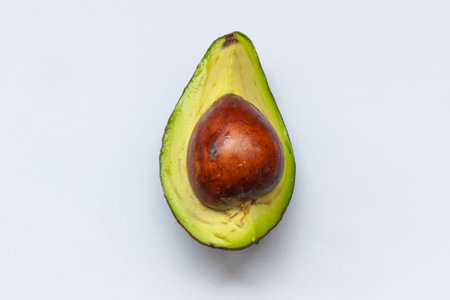 Top view of a cut avocado on a white background