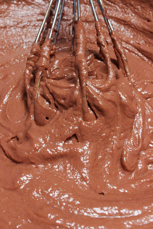 Whipping a melted chocolate dessert mix with a hand mixer