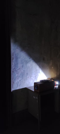 Homemade image projector showing old photographs in a dark room