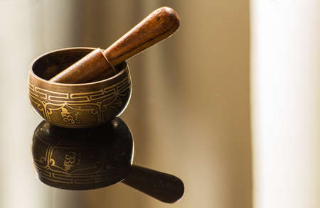 Tibetan bowl and its reflectionの写真素材