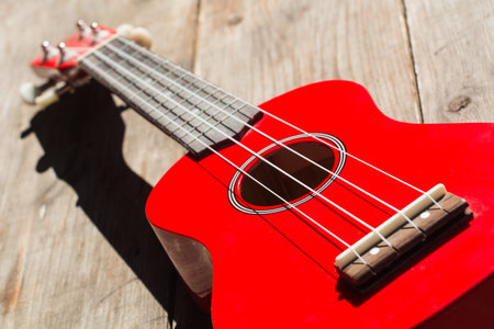 detail of the body and the keyboard of a red soprano ukulele