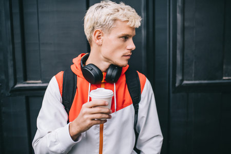 People, technology, lifestyle concept. Portrait of handsome Caucasian man looking at one side with...