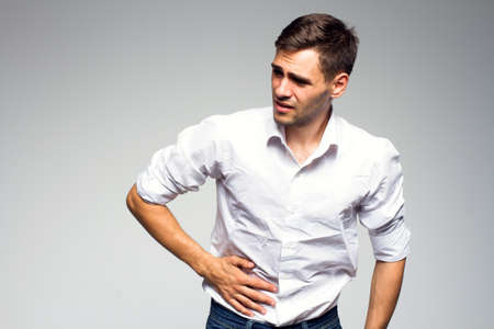 Businessman holding his stomach in painの写真素材