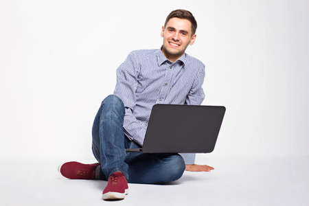 Business man with a laptop on a white backgroundの写真素材