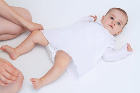 Beautiful baby with mother hands help on white background