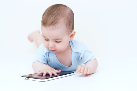 Beautiful baby playing with tablet.