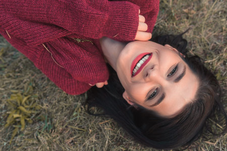 Above view of cheerful close up portrait of a beautiful young Caucasian woman smiling and looking at...