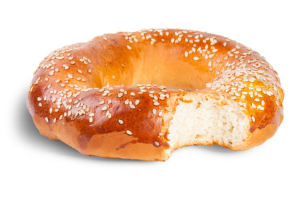 Bitten Bagel With Sesame Seeds Isolated On White Backgroundの写真素材