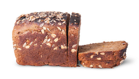 Half and slices of black unleavened bread with seeds isolated on white background